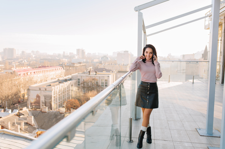 Header sunny morning big city terrace young brunette fashionable woman talking phone smiling attractive model woman chilling relaxing time happiness