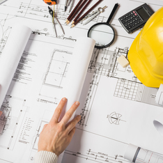 Thumb crop architect opening blueprint