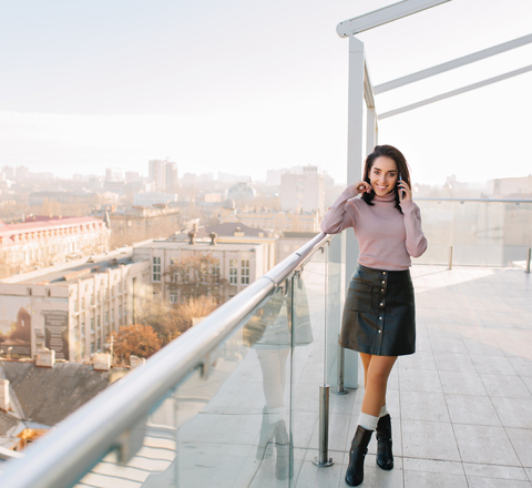 Vertical slider sunny morning big city terrace young brunette fashionable woman talking phone smiling attractive model woman chilling relaxing time happiness