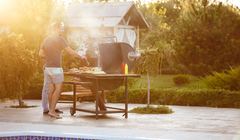 Wide thumb young men roasting barbecue grill cottage countryside